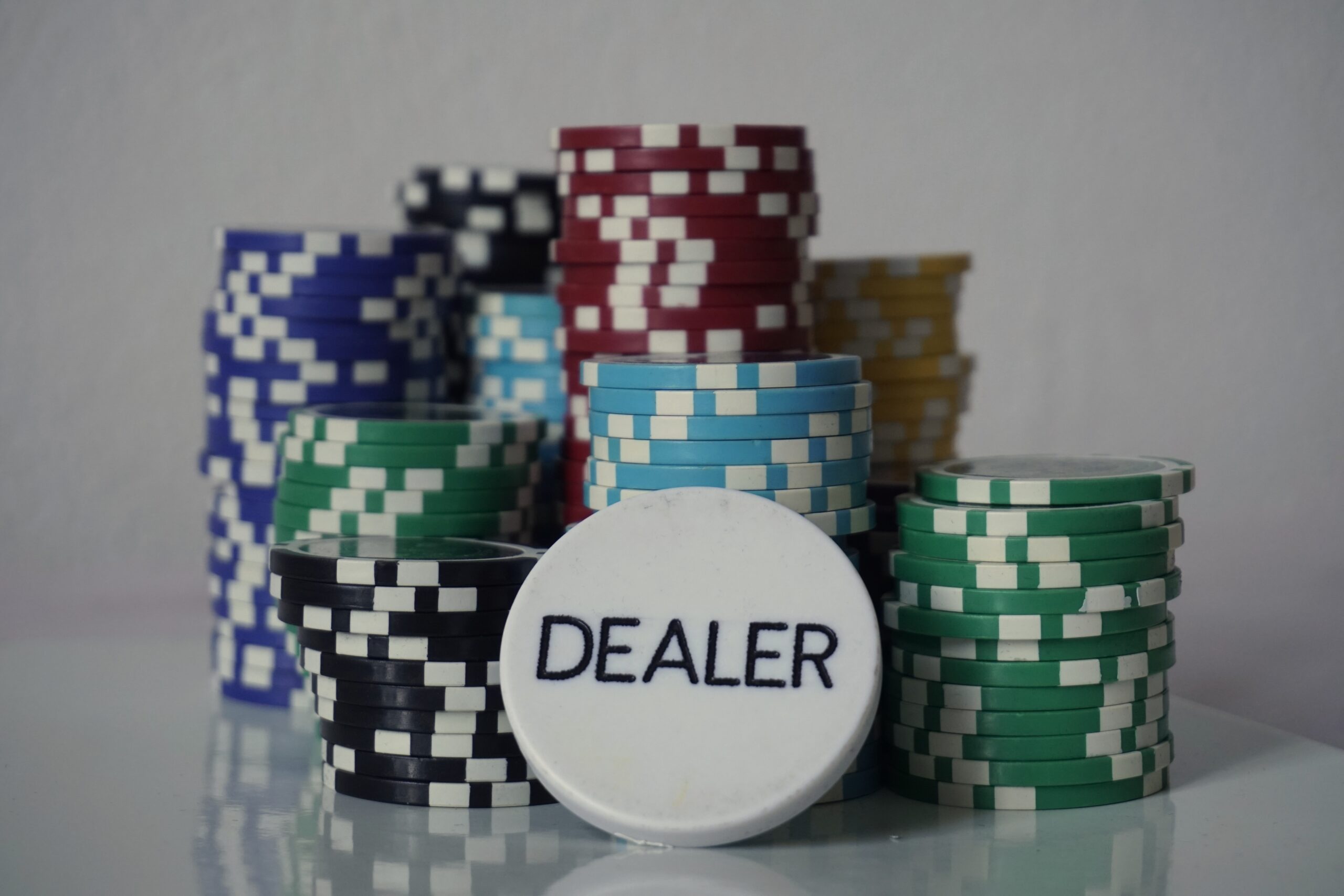 Chồng chip cược và nút dealer trên bàn bài
